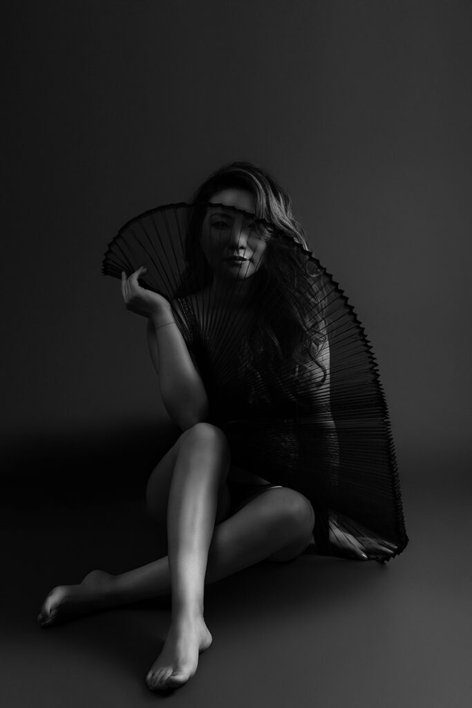 Beautiful bridal boudoir photo of bride in elegant lingerie, posed in natural light and studio light.
