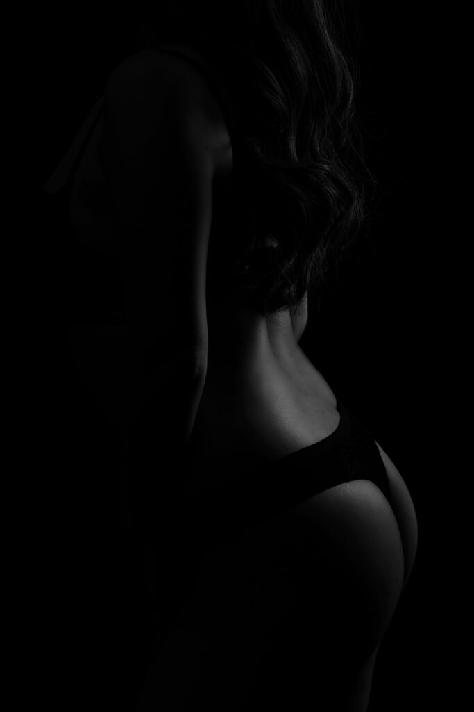 Beautiful bridal boudoir photo of bride in elegant lingerie, posed in natural light and studio light.