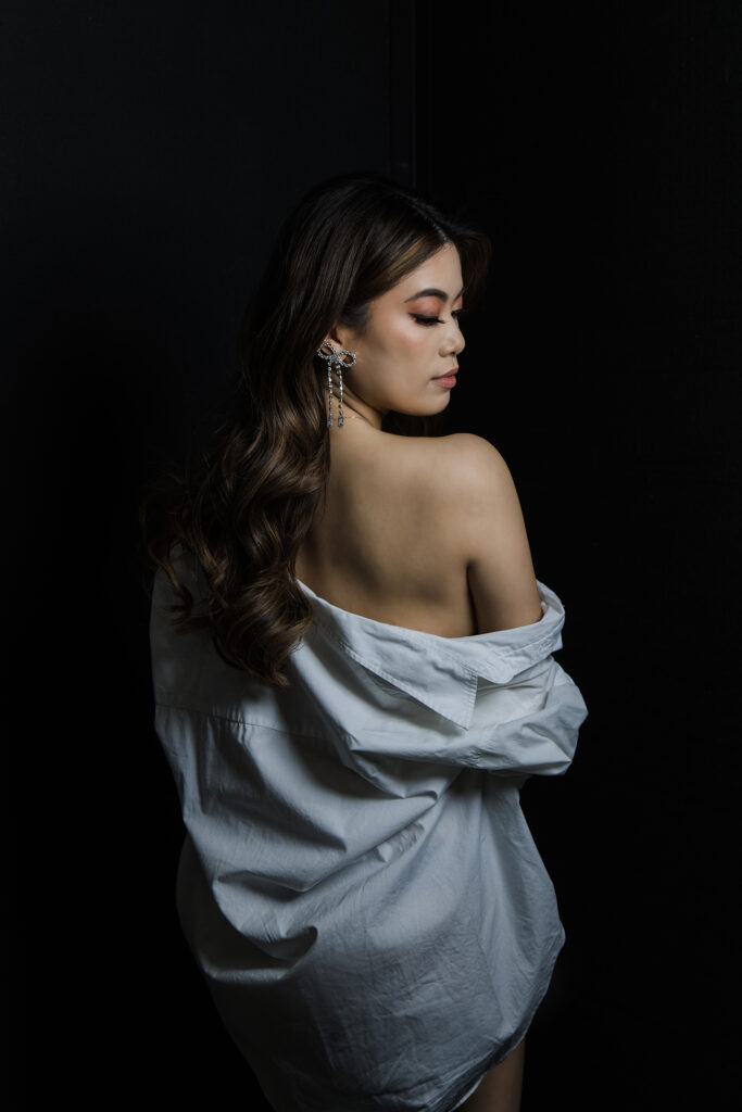 Beautiful bridal boudoir photo of bride in elegant lingerie, posed in natural light and studio light.