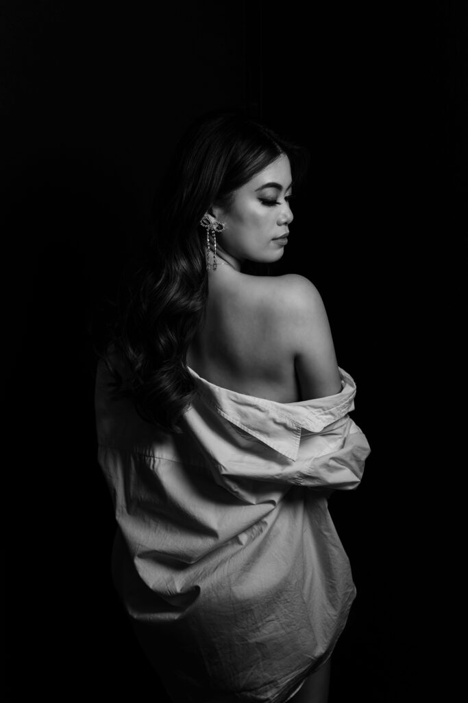 Beautiful bridal boudoir photo of bride in elegant lingerie, posed in natural light and studio light.
