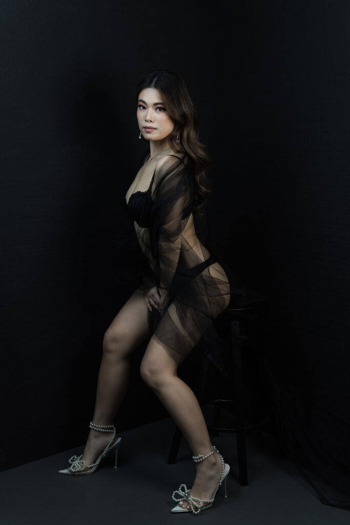 Beautiful bridal boudoir photo of bride in elegant lingerie, posed in natural light and studio light.