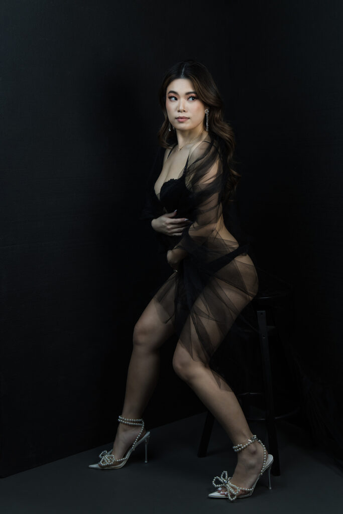 Beautiful bridal boudoir photo of bride in elegant lingerie, posed in natural light and studio light.